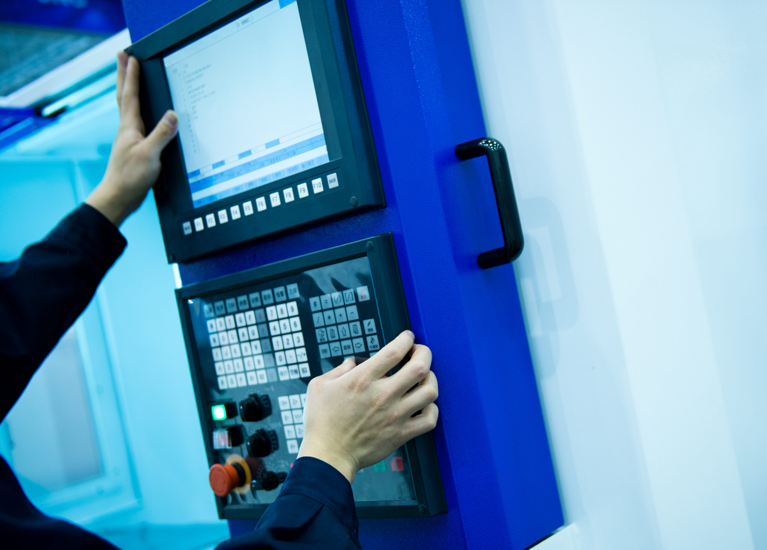 worker working with cnc machine at workshop.